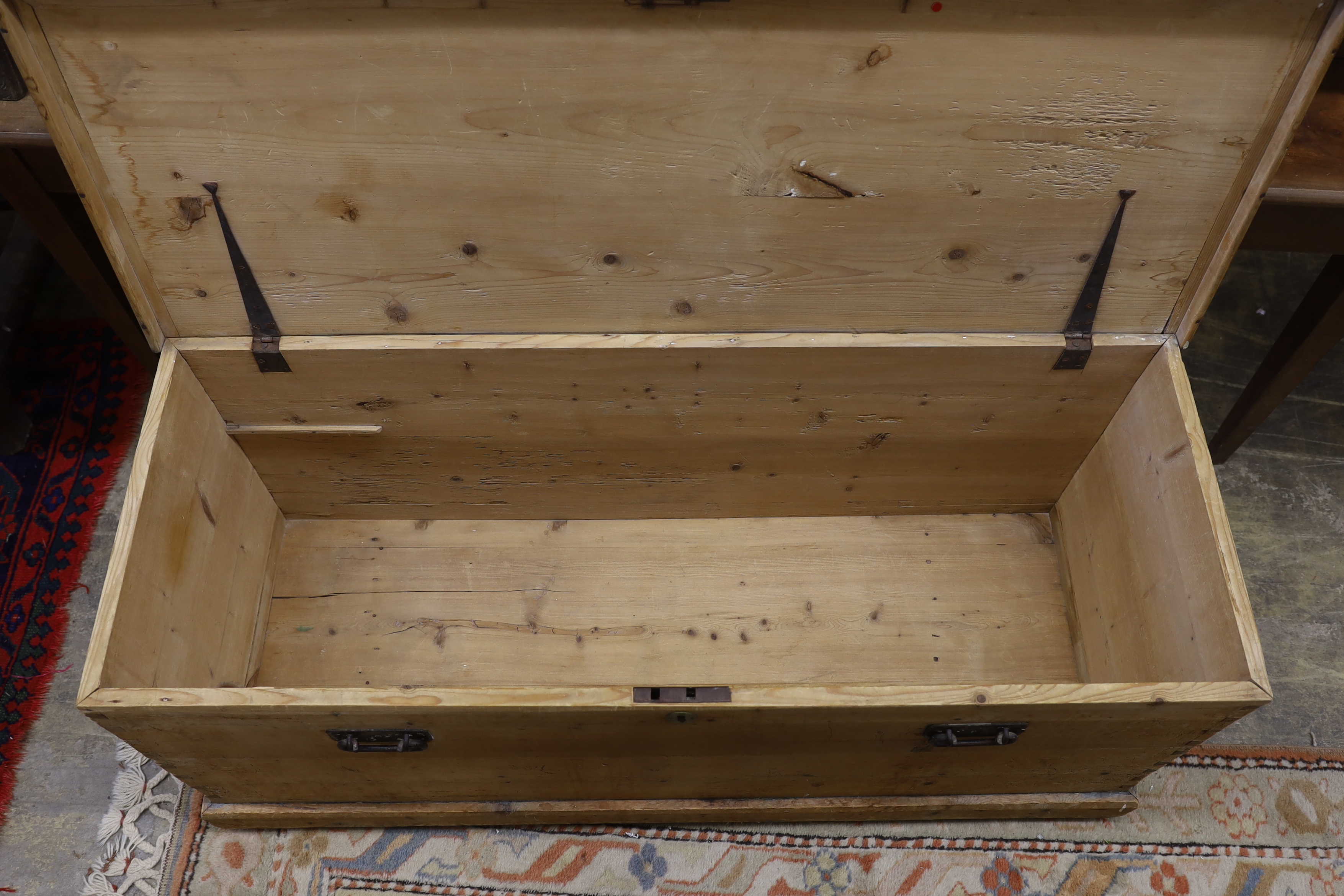 A Victorian pale pine trunk with iron handles, length 134cm, depth 49cm, height 58cm